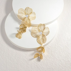 Exaggerated golden hollow flower earrings with pearl tassels and 18k gold plating