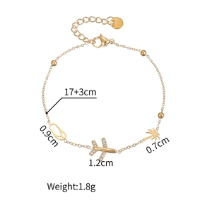 Gold-tone vacation bracelet with plane, coconut tree, and sandal charms with lobster clasp