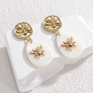 Gothic gold spider droplet earrings with white pearl-like pendants in minimalist style
