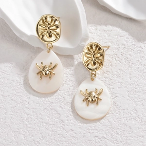 Retro golden spider drop earrings with white teardrop pendants and metallic finish