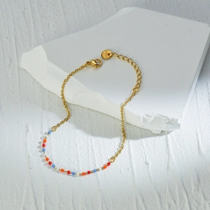 Gold stainless steel link bracelet featuring vibrant colorful beads and S.Steel tag
