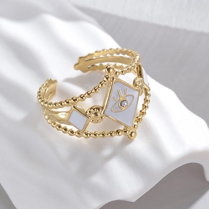 Detailed macro view of the gold Evil Eye ring with white enamel and diamond accents