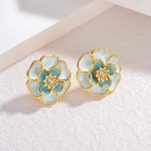 Elegant gold-plated camellia stud earrings with blue gradient enamel and crystal center