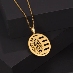 Golden stainless steel Tree of Life pendant necklace on a black geometric display stand