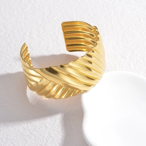 Polished gold wide cuff bracelet with chunky water ripple texture and wavy edges