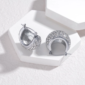 Elegant silver-toned half-hoop earrings featuring paved cubic zirconia on stone display