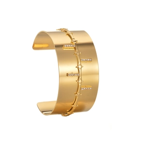 Gold plated wide cuff bracelet with rectangular diamond accents on white background