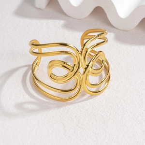 Exaggerated wide hollow gold cuff bracelet with geometric punk design on white background