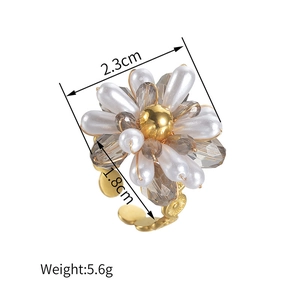 Golden flower ring with white pearls and grey crystals in a stylish beaded design