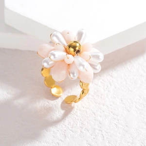 Elegant gold flower ring featuring pearl beads and pink crystals with adjustable band