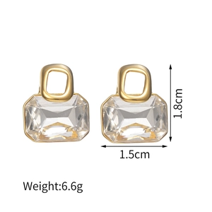 Detail view of 18k gold earrings with geometric zircon inlay measuring 1.8cm by 1.5cm