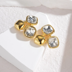 Golden stainless steel stud earrings with square cubic zirconia on a stone pedestal