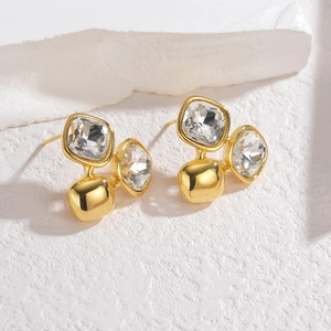 Minimalist 18K gold stainless steel earrings with square crystals on a white stone background