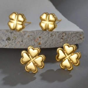 Elegant 18K gold plated stainless steel clover stud earrings on grey stone pedestal