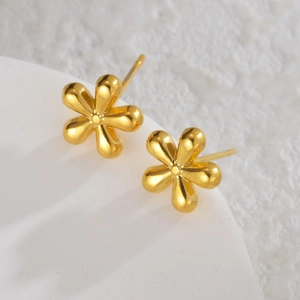Elegant 18K gold geometric flower earrings with six-petal design on textured base