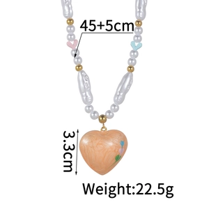 Detail of colorful pearl necklace with orange heart pendant and size specifications