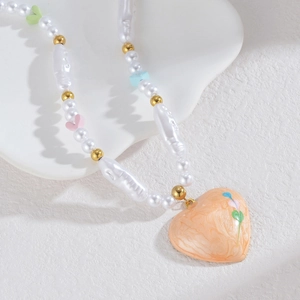 Dopamine pearl necklace with colorful heart beads and marble heart pendant on white stand