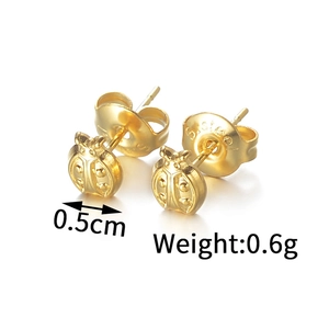 Macro detail of ladybug-shaped gold-plated stainless steel earrings with S.Steel stamp