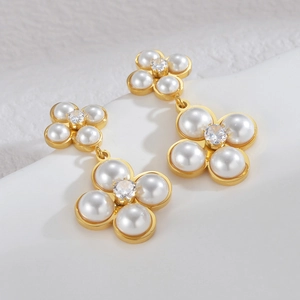 Elegant gold stainless steel earrings featuring white pearl flowers and zircon accents