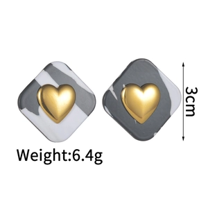 Detail of square marble pattern earrings with a gold heart center and size marking