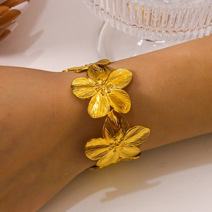 Adjustable wide stainless steel flower cuff bracelet with brushed metallic texture