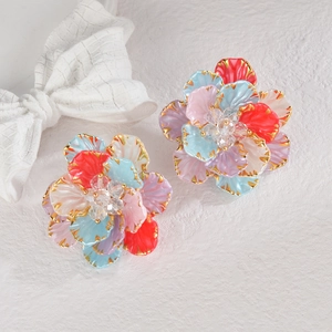 Colorful floral earrings with gold edges and center beads on white background