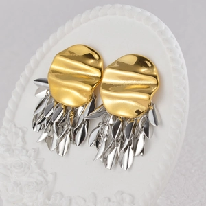 Modern 18K gold and silver two-tone fringe drop earrings on a white display stand