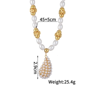 Detail of elegant pearl necklace with gold floral spacers and large teardrop pendant