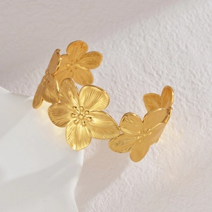 Minimalist gold cutout flower open cuff bracelet in brushed stainless steel finish