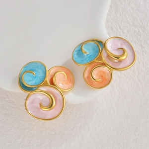 Macro detail of artistic geometric enamel stud earrings with marble texture and gold accents