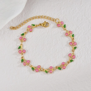 Detailed shot of cherry charm bracelet with pink glitter fruits and green enamel leaves