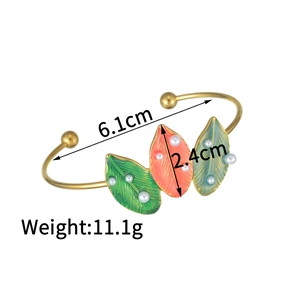 Bohemian 18K gold-plated cuff bracelet featuring colorful enamel leaves and size details