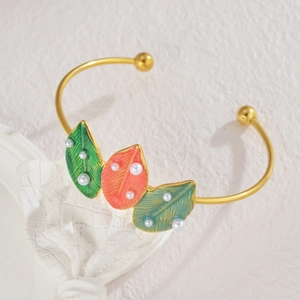 Exaggerated golden open bangle with colorful enamel leaves and pearls in retro style
