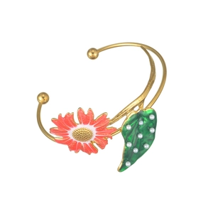 Exaggerated golden sunflower leaf open bangle with red enamel floral and pearl details
