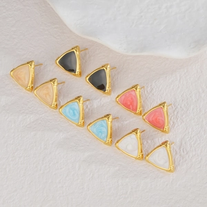 Detailed macro of gold triangular earrings featuring colorful marble texture inlay patterns