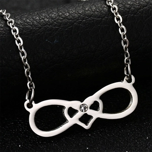 Macro shot of silver infinity necklace with double heart design and sparkling crystal