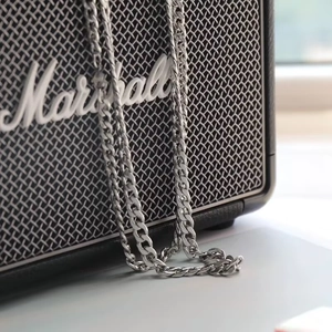 Minimalist 304 stainless steel cuban chain necklace displayed on a Marshall speaker