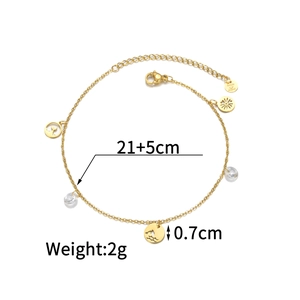 Detail of 18k gold plated anklet with whale tail and dolphin charms and size markings