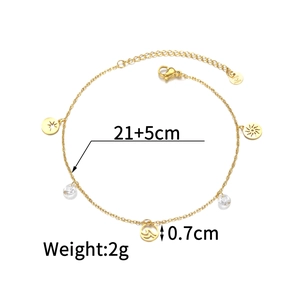 Detail of 18K gold-plated anklet showing star and sun charms with 21+5cm dimensions