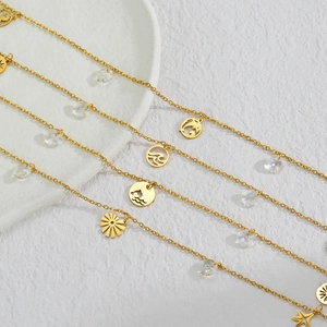Detail of 18K gold plated anklets with ocean charms like dolphin and starfish