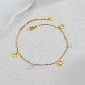 18K gold plated stainless steel anklet with sun, star and wave charms on white background