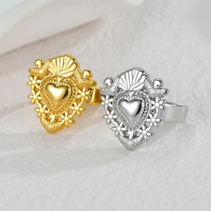 Exquisite 18K gold and silver heart-shaped rings with intricate floral and bird carvings