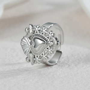 Bohemian style silver heart ring with flower and scallop relief in adjustable open design