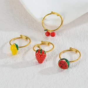 Detail showing four adjustable 18K gold plated rings with colorful fruit drip oil charms