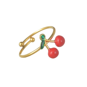 Adjustable gold plated cherry ring with red and green enamel fruit design on white background