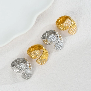 Detail of woven texture rings with pearlescent teardrop accents in gold and silver