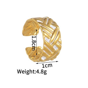 Detailed view of golden braided texture ring with white enamel accents and dimensions