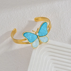 Bohemian gold butterfly open bangle with blue pearlescent wings and pearl accent