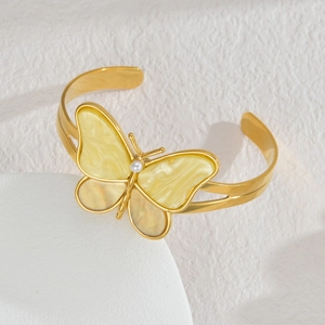 Elegant gold butterfly open bracelet with yellow marble enamel and white faux pearl accent