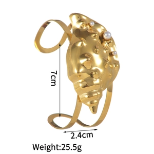 Detailed view of ocean-style gold seashell bracelet with pearls and 7cm diameter measurements